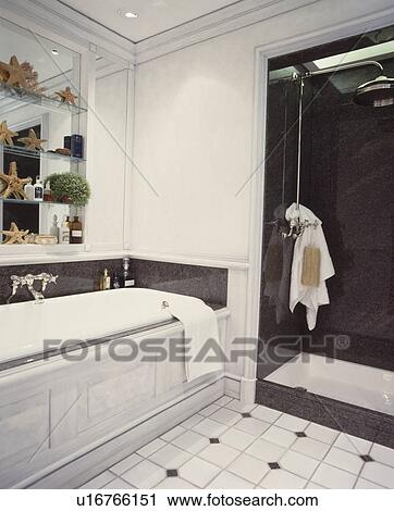 Grey panelled bath and large shower in town bathroom View Large Photo Image Stock Image - Grey panelled bath and large shower in town bathroom. Fotosearch