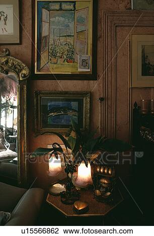 Group of pictures on wall in traditional living room with lighted Art Nouveau lamp View Large Photo Image Stock Image - Group of pictures on wall in traditional living room with lighted Art Nouveau lamp. Fotosearch