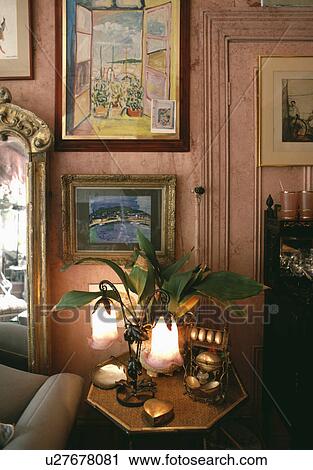 Group of pictures on wall in traditional living room with lighted Art Nouveau lamp View Large Photo Image Stock Image - Group of pictures on wall in traditional living room with lighted Art Nouveau lamp. Fotosearch