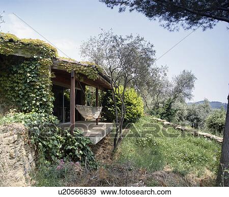 Stock Photo - Hammock on veranda of small country house in Southern France. Fotosearch