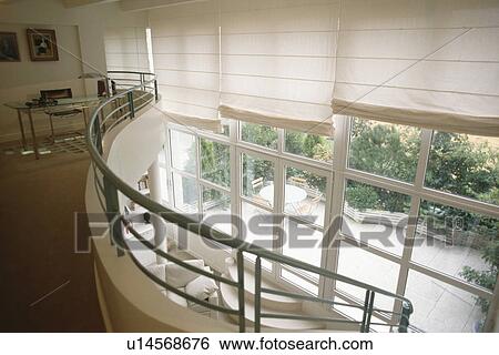 Home Office On Mezzanine With White Blinds On Floor To Ceiling Windows Stock Photograph