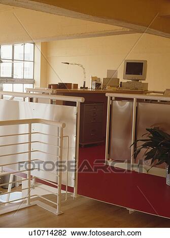 Stock Image - Home office on the top floor of modern loft conversion. Fotosearch