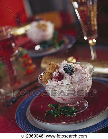 Icecream with maccaroon in stemmed glass bowl on red plate View Large Photo Image Stock Photograph - Icecream with maccaroon in stemmed glass bowl on red plate. Fotosearch