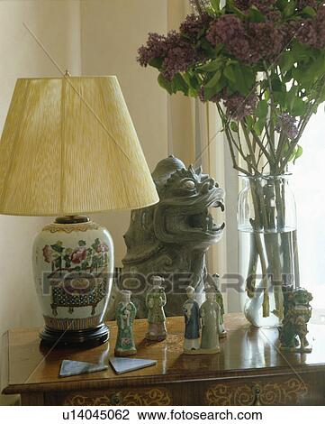 Lamp and sculpture on table View Large Photo Image Stock Image - Lamp and sculpture on table. Fotosearch