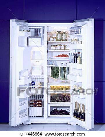 Picture - Large American style fridge freezer with doors open showing contents. &#13; &#10; &#13; &#10; &#13; &#10;. Fotosearch
