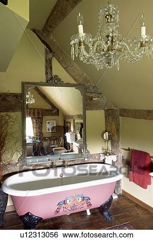 Large antique mirror above painted clawfoot bath in cream attic bathroom with glass chandelier View Large Photo Image Stock Photograph - Large antique mirror above painted clawfoot bath in cream attic bathroom with glass chandelier. Fotosearch
