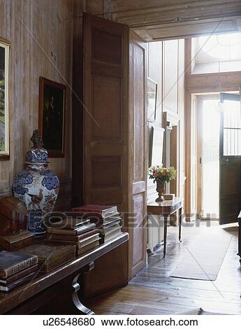 Large Chinese pot and old leatherbound books on antique table in small Georgian hall View Large Photo Image Stock Image - Large Chinese pot and old leatherbound books on antique table in small Georgian hall. Fotosearch