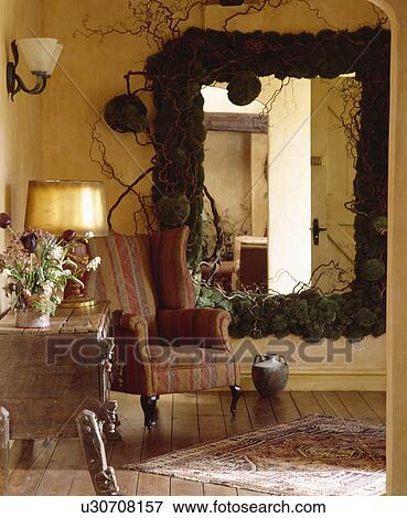 Large Moss Framed Mirror And Striped Armchair Stock Photo Moss Framed Mirror And Striped Armchair