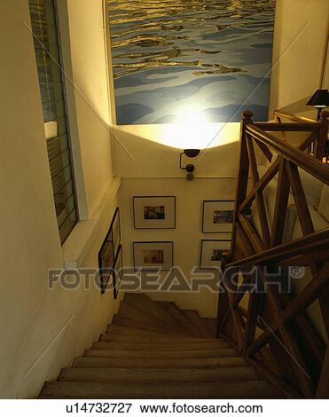 Large picture above staircase with angular wooden bannisters View Large Photo Image Stock Photo - Large picture above staircase with angular wooden bannisters. Fotosearch