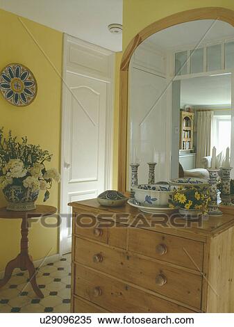 Large Pine Mirror Above Pine Chest Of Drawers In Small Yellow Hall