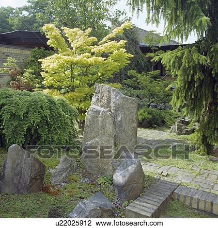 Large smooth stones and shrubs in green oriental-style garden View Large Photo Image Stock Image - Large smooth stones and shrubs in green oriental-style garden. Fotosearch