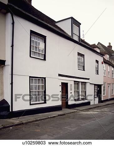 Stock Image - Large white terraced townhouse with dormer window. Fotosearch