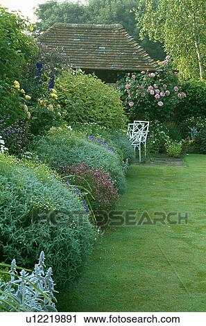 Lawn and herbaceous border in large country garden in summer View Large Photo Image Stock Image - Lawn and herbaceous border in large country garden in summer. Fotosearch