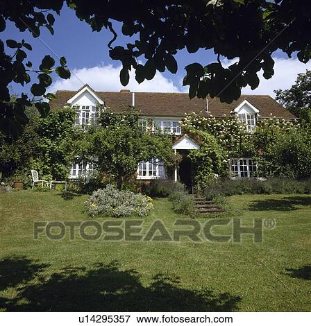 Stock Photo - Lawn in summer country garden. Fotosearch