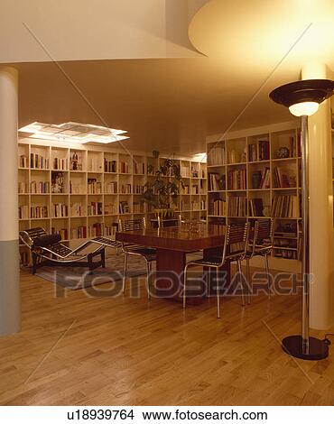 Le Corbusier chaiselongue in twenties style dining room with parquet floors and shelving on walls  View Large Photo Image Picture - Le Corbusier chaiselongue in twenties style dining room with parquet floors and shelving on walls . Fotosearch