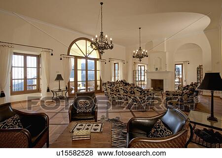 Leather armchairs and terracotta tiled floor in large living room in Spanish villa View Large Photo Image Stock Photo - Leather armchairs and terracotta tiled floor in large living room in Spanish villa. Fotosearch
