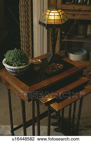 Lighted Art Nouveau lamp on nest-of-tables View Large Photo Image Stock Image - Lighted Art Nouveau lamp on nest-of-tables. Fotosearch