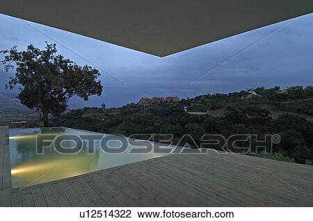 Lighted infinity pool at night at Spanish hillside villa View Large Photo Image Stock Image - Lighted infinity pool at night at Spanish hillside villa. Fotosearch