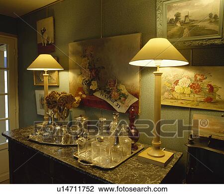Lighted lamps below group of pictures on wall View Large Photo Image Stock Image - Lighted lamps below group of pictures on wall . Fotosearch