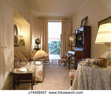 Stock Photo - Lighted lamps in traditional living room. Fotosearch