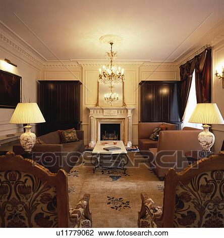 Lighted lamps on table in traditional living room View Large Photo Image Stock Image - Lighted lamps on table in traditional living room. Fotosearch