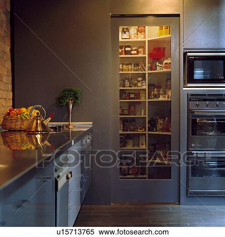 Lighting above shelves in tall cupboard with glass door in modern kitchen View Large Photo Image Stock Photography - Lighting above shelves in tall cupboard with glass door in modern kitchen. Fotosearch
