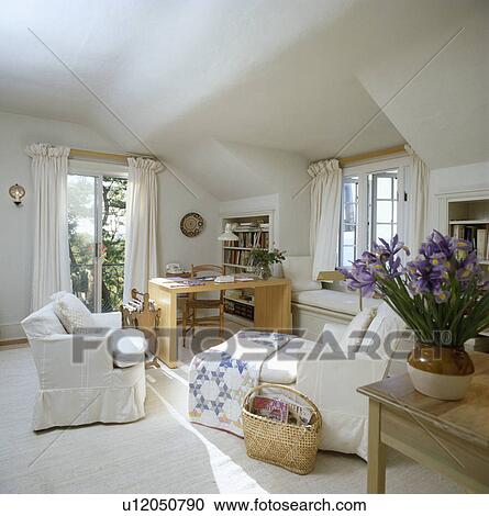 Stock Image - Livingroom with desk in the corner painted white.. Fotosearch