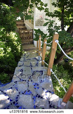 Looking down on blue mosaic steps between trees to Spanish house View Large Photo Image Stock Photograph - Looking down on blue mosaic steps between trees to Spanish house . Fotosearch