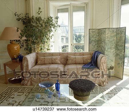 Loosecover on sofa in traditional living room with screen in front of window View Large Photo Image Stock Photo - Loosecover on sofa in traditional living room with screen in front of window. Fotosearch