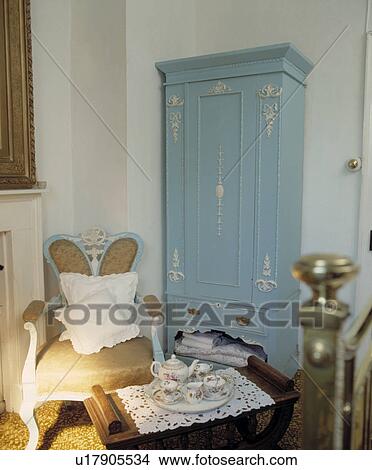 Louis Iv Style Armchair And Painted Blue Wardrobe In Bedroom