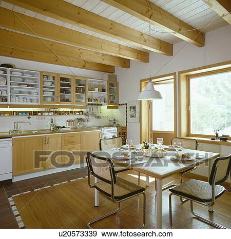 Stock Photo - Marcel Breuer dining chairs in modern German kitchen diningroom with wooden floor and beams&#13; &#10; &#13; &#10;. Fotosearch