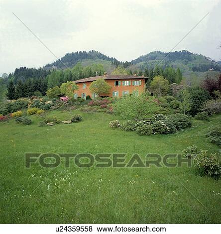 Stock Photo - Meadow in front Italian villa in Tuscany. Fotosearch