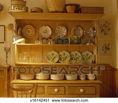 Metal Lamp Clipped To Old Pine Dresser With Glasses And Patterned