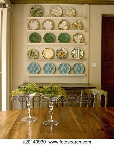 Mimosa in stemmed glasses on table in dining room with antique green and turquoise plates on white shelves View Large Photo Image Stock Image - Mimosa in stemmed glasses on table in dining room with antique green and turquoise plates on white shelves. Fotosearch