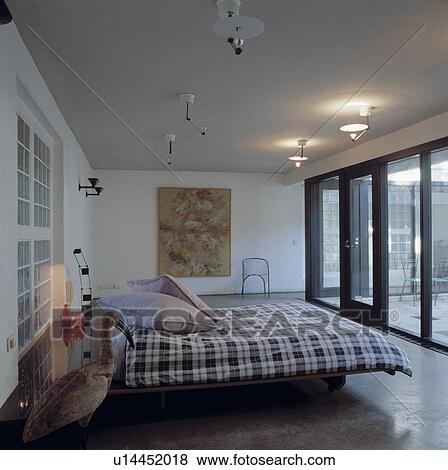 Modern bedroom overlooking patio View Large Photo Image Stock Photo - Modern bedroom overlooking patio. Fotosearch