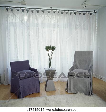 Modern chairs with loosecovers in front of window with white voile curtain View Large Photo Image Picture - Modern chairs with loosecovers in front of window with white voile curtain. Fotosearch