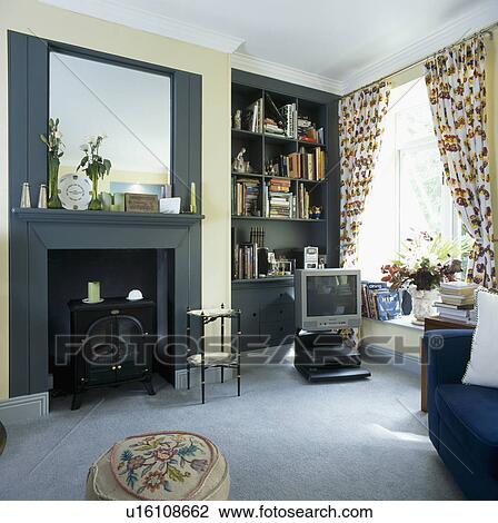 Stock Image - Modern living room with television and grey carpet. Fotosearch