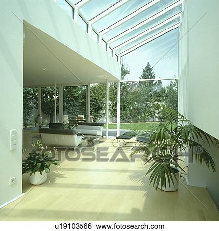 Stock Photograph - Modern living room with wooden floor and glass extension. Fotosearch