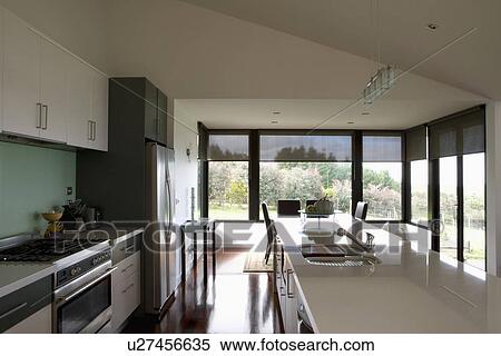 Modern streamlined kitchen and dining area, Australia View Large Photo Image Stock Photography - Modern streamlined kitchen and dining area, Australia . Fotosearch