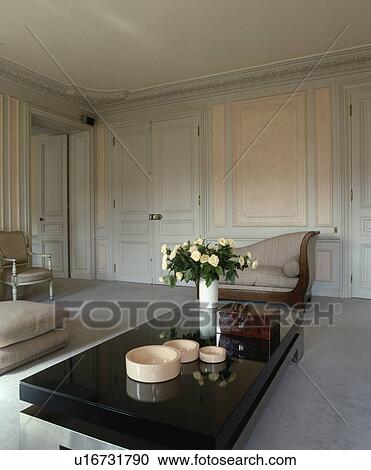 Modern table in traditional panelled living room View Large Photo Image Stock Image - Modern table in traditional panelled living room. Fotosearch