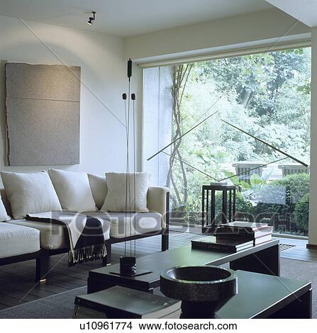 Picture - Modern white living room with white sofa and large window. Fotosearch
