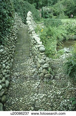 Mosaic pebble paving on stone bridge with pebble walls in large country garden View Large Photo Image Stock Photo - Mosaic pebble paving on stone bridge with pebble walls in large country garden. Fotosearch