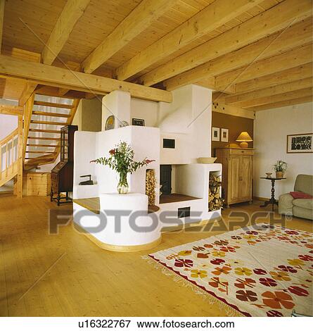 Stock Photo - moulded fireplace in traditional Scandinavian living room with beamed ceiling and wooden floor. Fotosearch