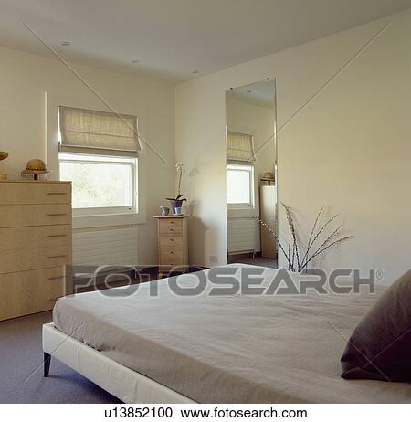 Neutral modern bedroom with beige linen on bed View Large Photo Image Stock Image - Neutral modern bedroom with beige linen on bed. Fotosearch