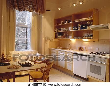 Neutral townhouse kitchen with spotlighting above open shelves View Large Photo Image Stock Image - Neutral townhouse kitchen with spotlighting above open shelves . Fotosearch