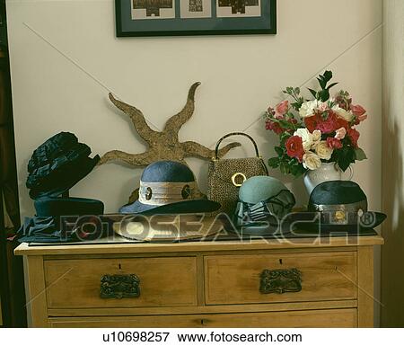 Stock Photo - Old felt hat collection and sculpture on pine chest of drawers. Fotosearch