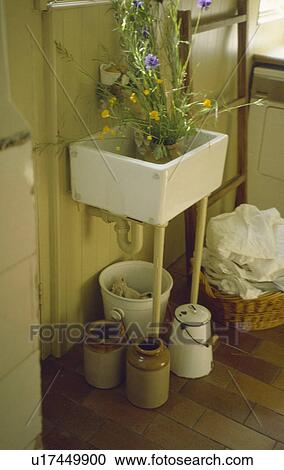 Old square ceramic sink above earthenware storage jars and basket of washing View Large Photo Image Stock Image - Old square ceramic sink above earthenware storage jars and basket of washing. Fotosearch