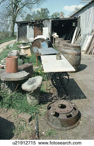 Stock Photography - Old tables and wooden barrels outside reclamation yard. Fotosearch