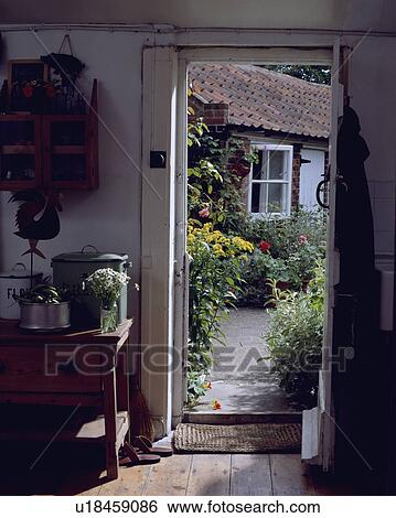 Open door in small white cottage hall with view of the garden View Large Photo Image Stock Photograph - Open door in small white cottage hall with view of the garden. Fotosearch