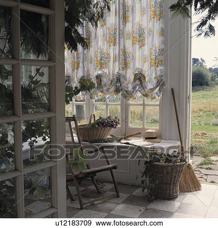 Open doors from this traditional conservatory lead out into the garden with views of the surrounding countryside. View Large Photo Image Stock Photo - Open doors from this traditional conservatory lead out into the garden with views of the surrounding countryside.. Fotosearch